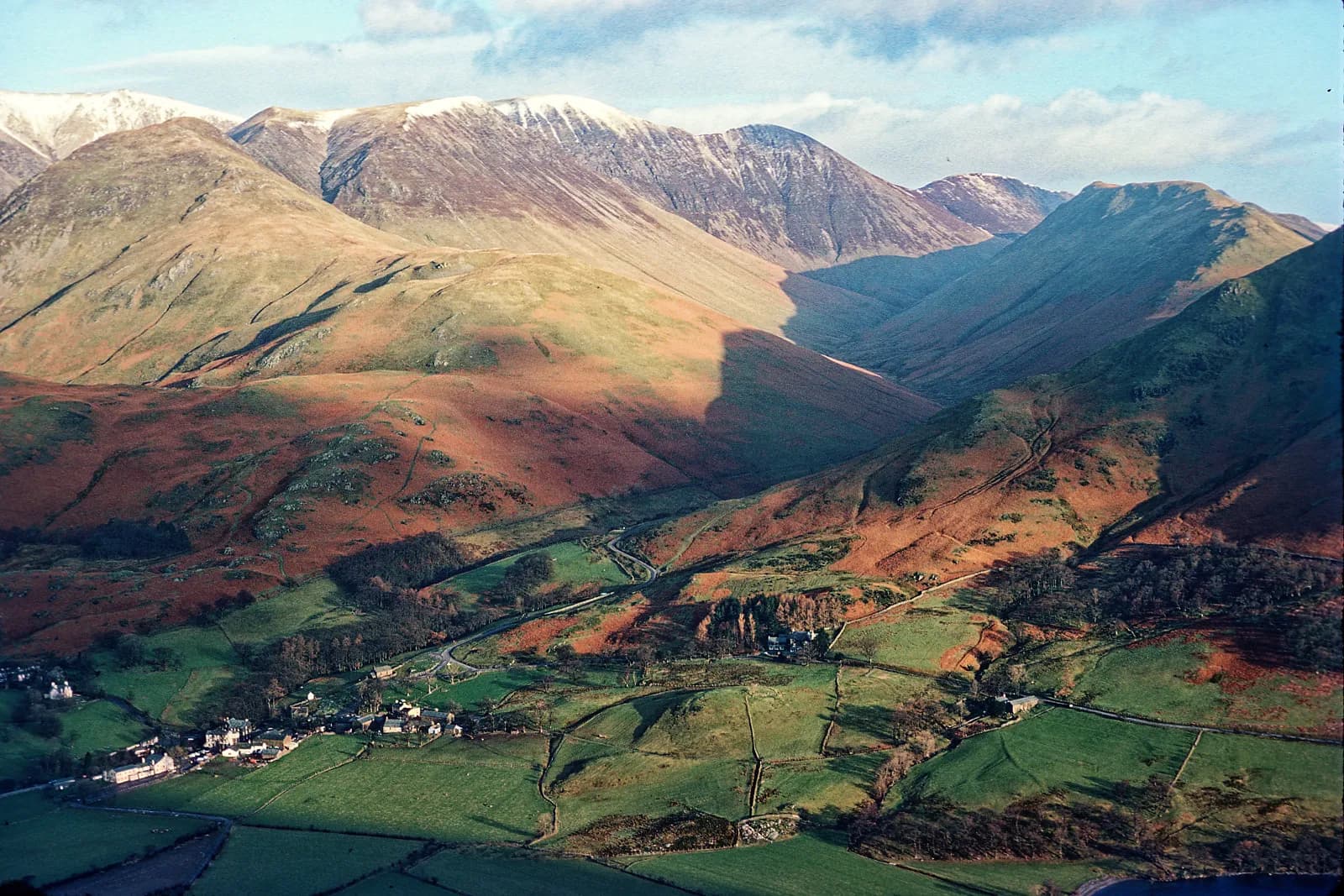 Buttermere village among green fields below the High Stile range and Fleetwith Pike