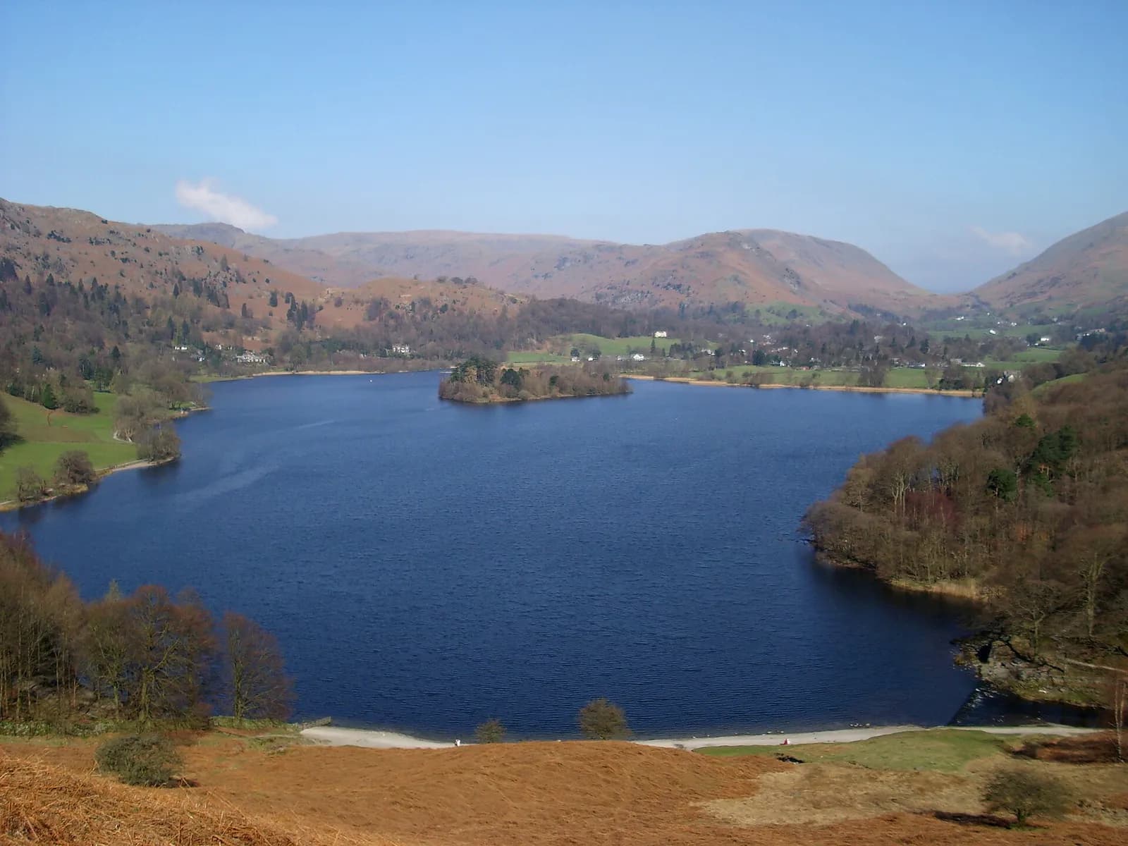 Grasmere lake and its wooded island seen from Loughrigg Terrace, with the village beyond