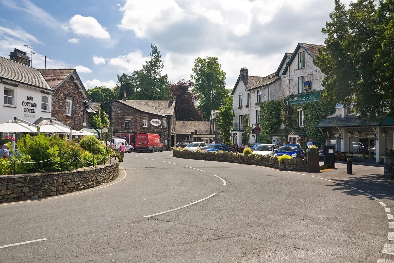 The centre of Grasmere village with slate-built inns and houses beneath wooded fells