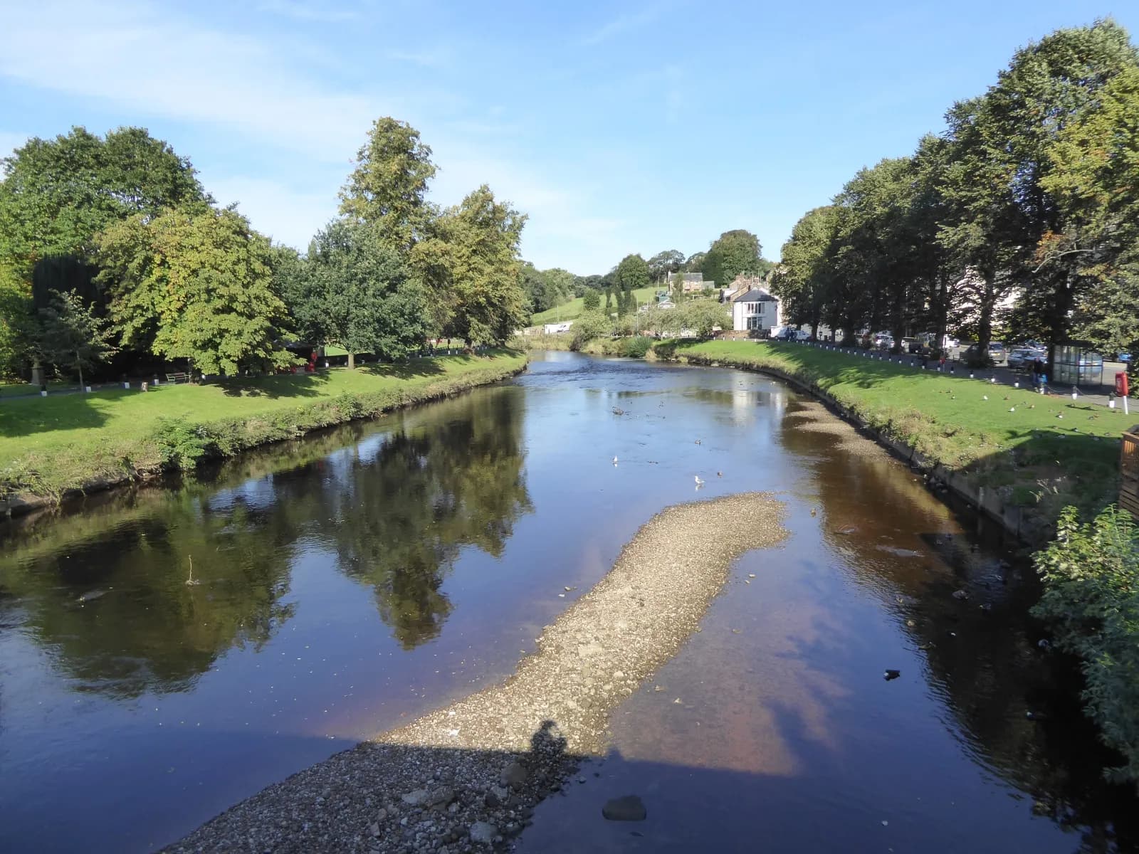 The River Eden flowing through Appleby between tree-lined grassy banks