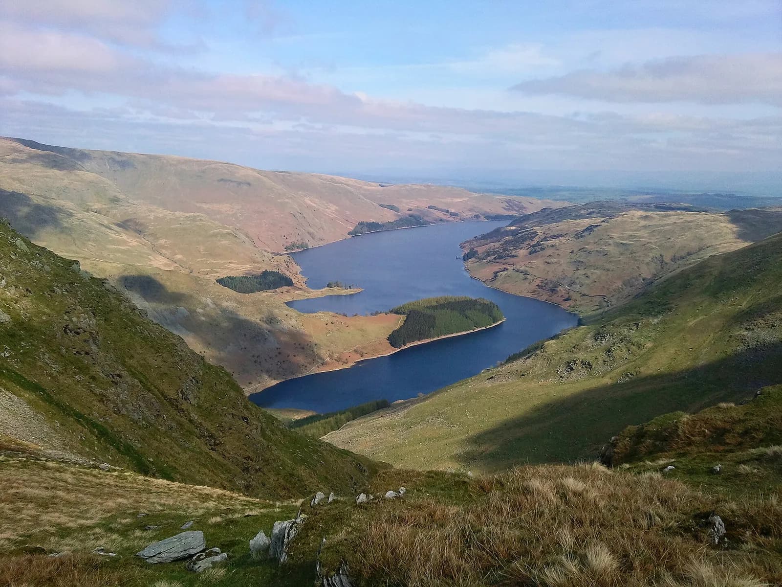 Haweswater reservoir winding between the fells, seen from high above Mardale