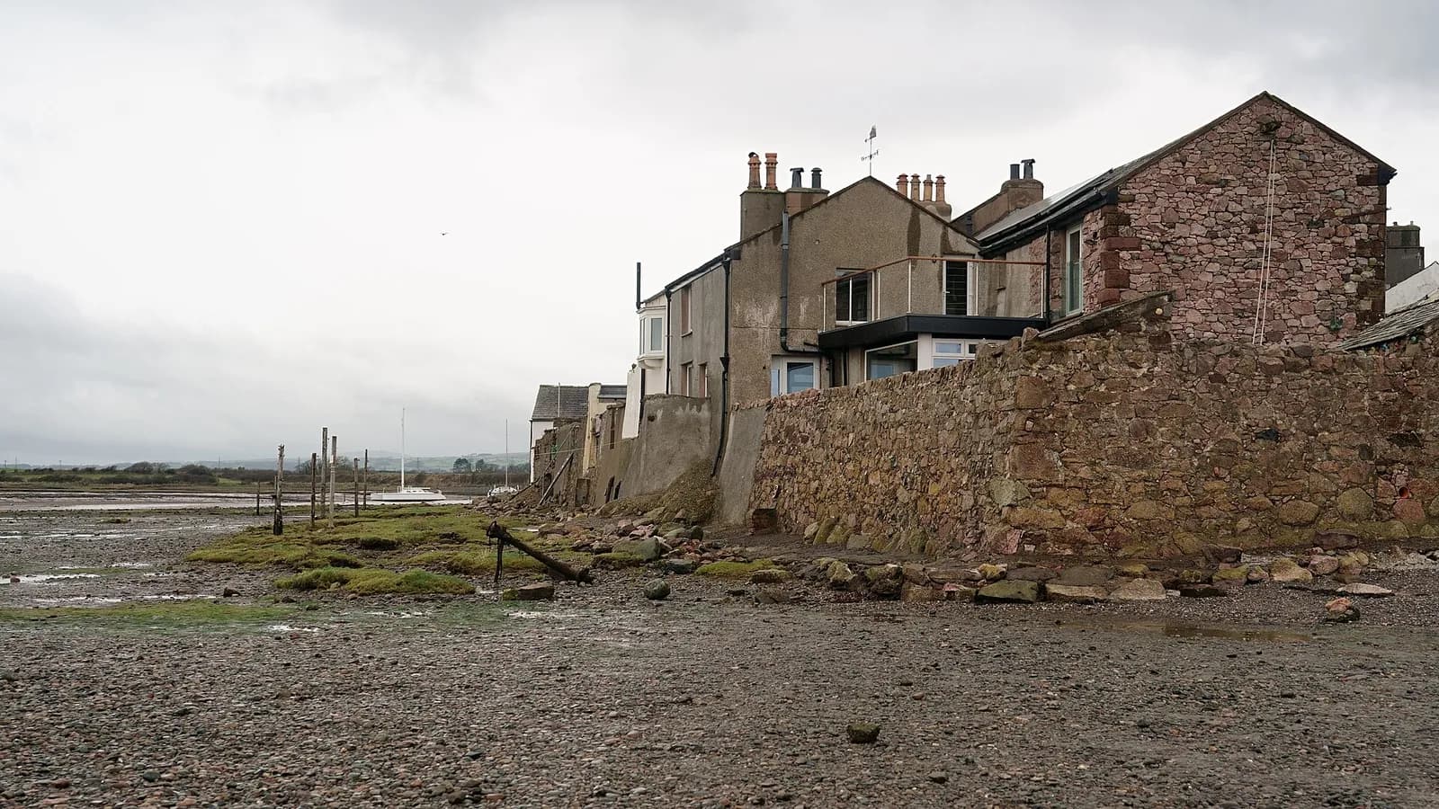 Sandstone houses on the shore at Ravenglass above the estuary at low tide