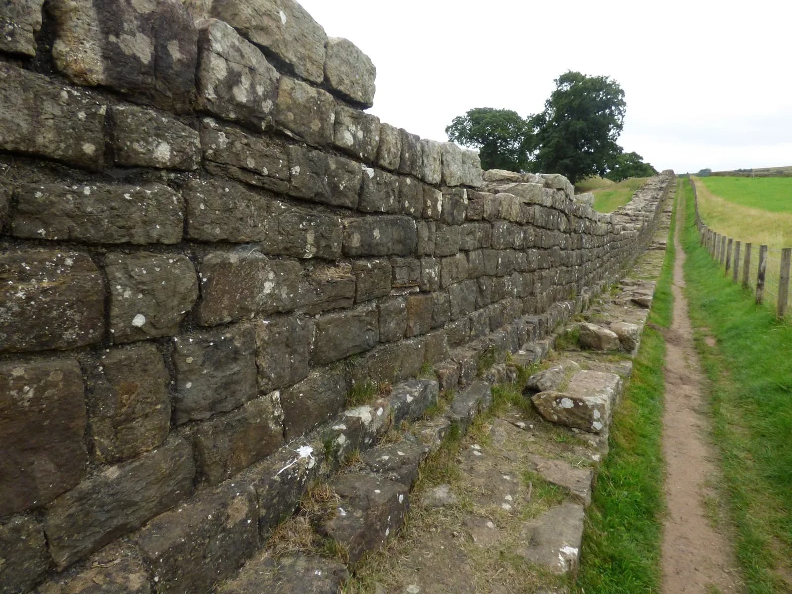 A long stretch of Hadrian's Wall with the walkers' path beside it at Willowford