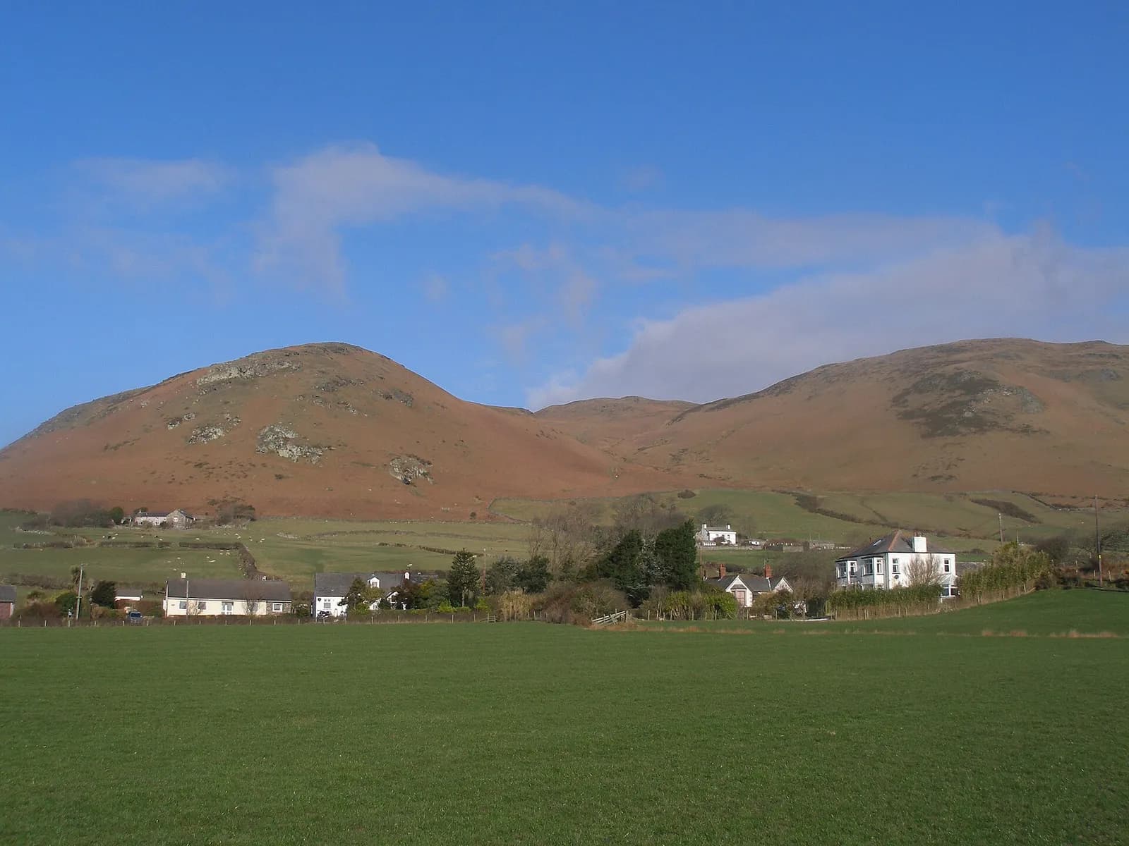 Black Combe rising behind the hamlet of Whicham