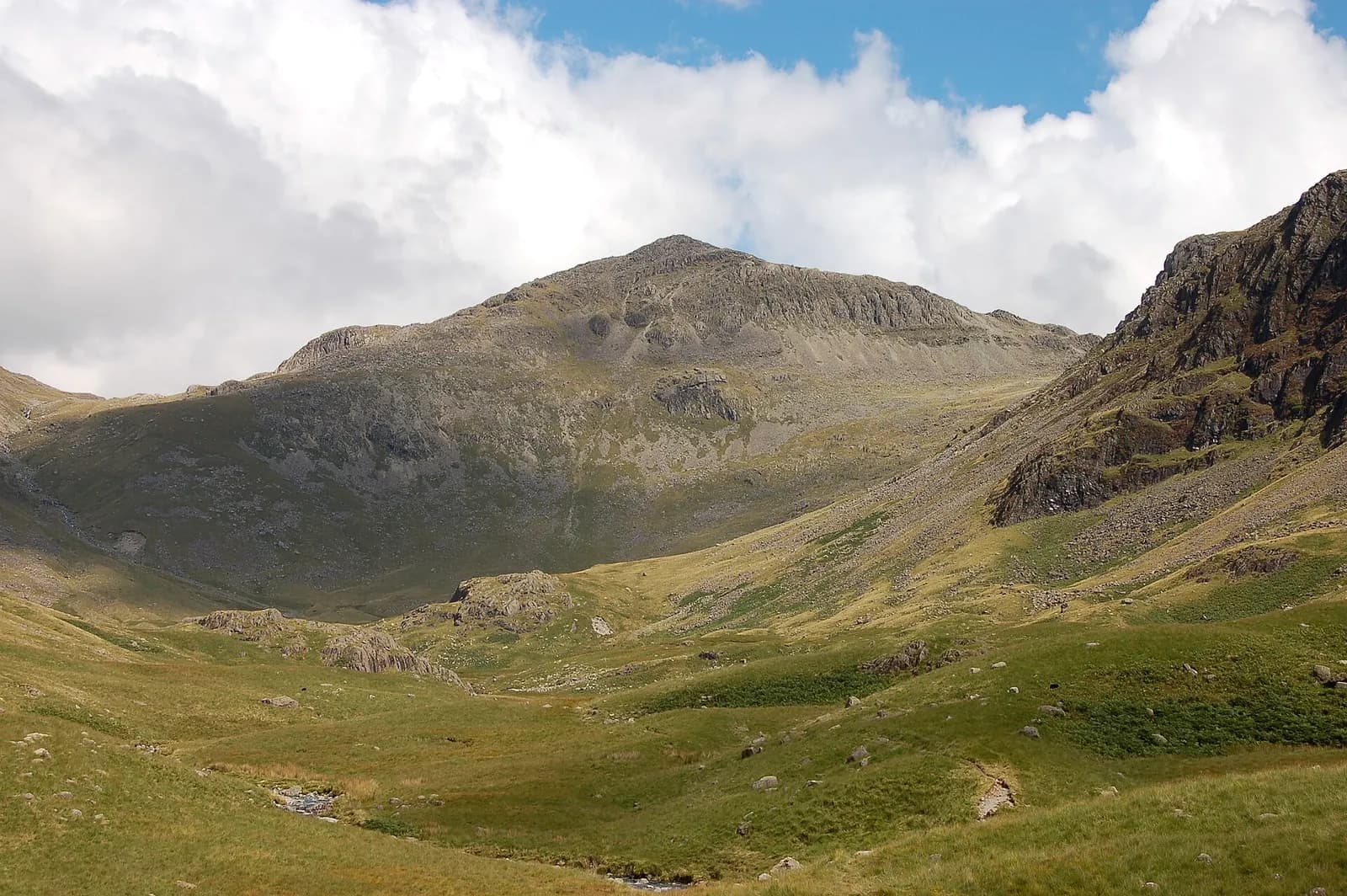 The summit dome of Bowfell above the upper valleys