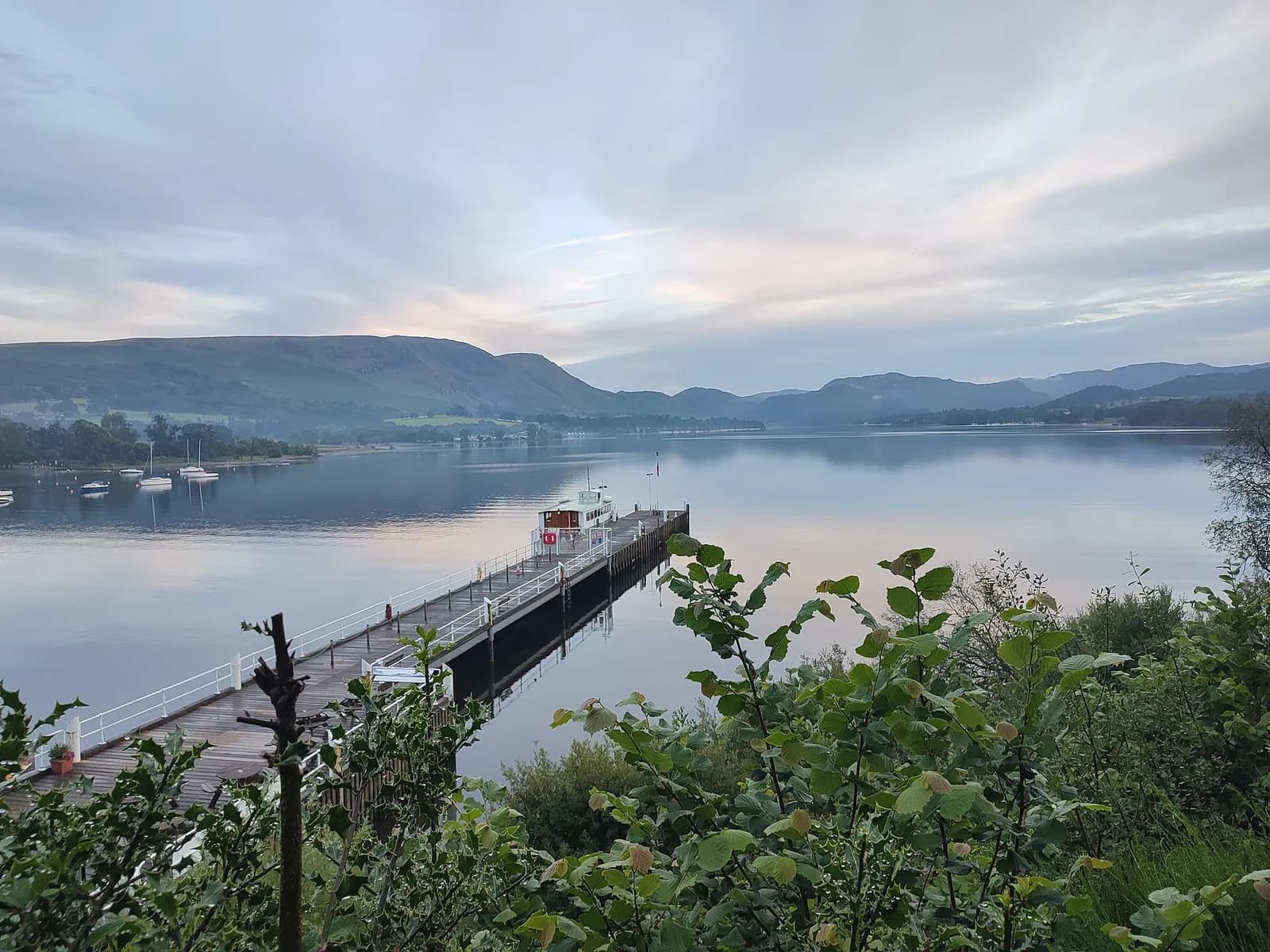 Ullswater and the Pooley Bridge pier seen from the wooded side of Dunmallard Hill