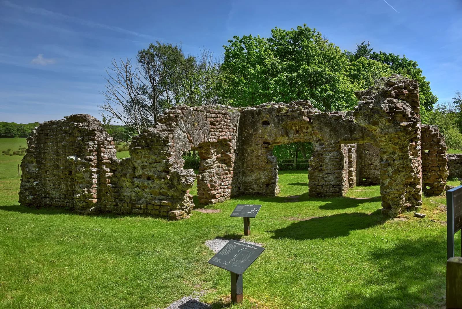 The tall red sandstone walls of the Roman bath house at Ravenglass